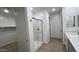 Walk-in shower, white vanity and tile flooring in new home bathroom at 15765 W Cheryl Dr, Waddell, AZ 85355