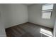 Empty bedroom with neutral carpet, white walls, and a window allowing natural light at 15765 W Cheryl Dr, Waddell, AZ 85355