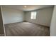 Bright bedroom featuring neutral carpet, light-colored walls, and a window providing natural light at 15765 W Cheryl Dr, Waddell, AZ 85355