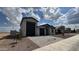 A single-story home with a paved driveway, two-car garage, and well-kept front yard at 15765 W Cheryl Dr, Waddell, AZ 85355