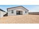 View of the back of the house, showcasing the stucco and dark roof at 15765 W Cheryl Dr, Waddell, AZ 85355