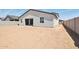 Exterior of home featuring stucco, a dark roof and a dirt backyard at 15765 W Cheryl Dr, Waddell, AZ 85355