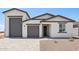 Charming single-story home featuring a three-car garage and desert landscaping at 15765 W Cheryl Dr, Waddell, AZ 85355