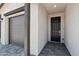 View of home entrance featuring a dark front door and access to the garage at 15765 W Cheryl Dr, Waddell, AZ 85355