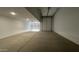 This spacious two car garage has a white walls and concrete floors at 15765 W Cheryl Dr, Waddell, AZ 85355