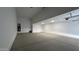 Spacious garage with concrete floor and modern lighting, offering ample room for storage at 15765 W Cheryl Dr, Waddell, AZ 85355