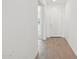 Bright hallway with wood-look flooring and a white front door at 15765 W Cheryl Dr, Waddell, AZ 85355