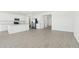 Open-concept kitchen with white cabinets, stainless steel appliances, and an island at 15765 W Cheryl Dr, Waddell, AZ 85355
