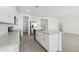 Modern kitchen with white cabinets, stainless appliances, island and hardwood style floors at 15765 W Cheryl Dr, Waddell, AZ 85355