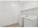 Laundry room complete with a washer, dryer and storage shelving at 15765 W Cheryl Dr, Waddell, AZ 85355
