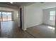 An open living room with carpet and tile flooring, ample light, and neutral color palette at 15765 W Cheryl Dr, Waddell, AZ 85355