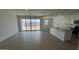 Open-concept living space with sliding glass doors to the backyard at 15765 W Cheryl Dr, Waddell, AZ 85355