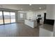 Bright, open floor plan with kitchen island and backyard views at 15765 W Cheryl Dr, Waddell, AZ 85355