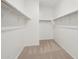 Spacious walk-in closet featuring carpeted floor and metal shelving at 15765 W Cheryl Dr, Waddell, AZ 85355