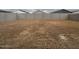 Unfinished backyard surrounded by block walls, ready for landscaping and outdoor customization at 15778 W Cheryl Dr, Waddell, AZ 85355
