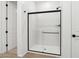 Modern bathroom features a glass shower with matte black trim and fixtures at 15778 W Cheryl Dr, Waddell, AZ 85355