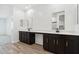 Bathroom showcasing dual sinks, quartz countertops, and dark cabinets at 15778 W Cheryl Dr, Waddell, AZ 85355