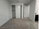 Spacious bedroom featuring a sliding-door closet and plush carpet at 15778 W Cheryl Dr, Waddell, AZ 85355