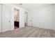 Carpeted bedroom features white walls, double closets, and an open doorway to the bathroom at 15778 W Cheryl Dr, Waddell, AZ 85355