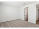 Cozy carpeted bedroom includes double closets and an open doorway at 15778 W Cheryl Dr, Waddell, AZ 85355