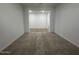 Bedroom featuring a view into the next room, with neutral walls and plush carpet at 15778 W Cheryl Dr, Waddell, AZ 85355