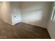 Bedroom with wood-look flooring, large closet, and plenty of natural light at 15778 W Cheryl Dr, Waddell, AZ 85355