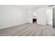 Minimalist bedroom with light gray carpet, leading to a bathroom and hallway at 15778 W Cheryl Dr, Waddell, AZ 85355