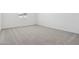 Neutral bedroom with gray carpet, window, and minimalist design at 15778 W Cheryl Dr, Waddell, AZ 85355