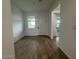 Bright foyer showcasing wood-look flooring and direct access to various living spaces at 15778 W Cheryl Dr, Waddell, AZ 85355