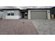 Charming single-story home featuring a brick driveway and a two-car garage at 15778 W Cheryl Dr, Waddell, AZ 85355