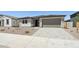 Street view of a cozy single-Gathering home with desert landscaping and a spacious two-car garage at 15778 W Cheryl Dr, Waddell, AZ 85355