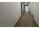 Hallway featuring wood-look floors and leading to the main living area at 15778 W Cheryl Dr, Waddell, AZ 85355