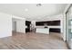 Bright, open kitchen and living area with dark cabinets, stainless appliances, and hardwood floors at 15778 W Cheryl Dr, Waddell, AZ 85355