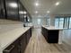 Kitchen boasting dark cabinets, a white subway tile backsplash, and modern lighting at 15778 W Cheryl Dr, Waddell, AZ 85355