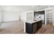 Kitchen island featuring a stainless steel dishwasher and sink with a gold faucet at 15778 W Cheryl Dr, Waddell, AZ 85355