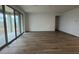 Open-concept living room featuring wood floors and large sliding glass doors at 15778 W Cheryl Dr, Waddell, AZ 85355