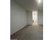 Spacious living room with neutral carpet, light walls, and an open doorway to the kitchen at 15778 W Cheryl Dr, Waddell, AZ 85355