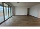 Spacious living room with sliding glass doors and wood-look flooring at 15778 W Cheryl Dr, Waddell, AZ 85355