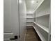 Walk-in pantry with ample shelving space for organized storage at 15778 W Cheryl Dr, Waddell, AZ 85355