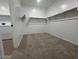 Carpeted walk-in closet featuring built-in shelving and a laundry area with washer and dryer hookups at 15778 W Cheryl Dr, Waddell, AZ 85355