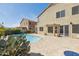 Expansive backyard featuring a sparkling pool, tile patio, and neutral-colored stucco exterior at 15825 S 1St Ave, Phoenix, AZ 85045