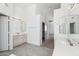 Bright bathroom featuring tile floors, double vanity, framed mirrors and a separate shower area at 15825 S 1St Ave, Phoenix, AZ 85045