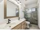 Bathroom featuring a shower stall, tile floors, dual sink vanity, and framed mirror at 15825 S 1St Ave, Phoenix, AZ 85045