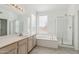 Bright bathroom featuring a soaking tub and walk-in shower at 15825 S 1St Ave, Phoenix, AZ 85045