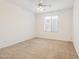 Bedroom featuring carpeted floors, ceiling fan and a window with exterior view at 15825 S 1St Ave, Phoenix, AZ 85045
