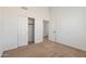 Bedroom featuring neutral carpet, closet with double doors, and a door to another room at 15825 S 1St Ave, Phoenix, AZ 85045