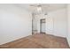 Carpeted bedroom with ceiling fan, closet and access to another room via a doorway at 15825 S 1St Ave, Phoenix, AZ 85045