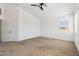 Spacious carpeted bedroom featuring vaulted ceiling with fan and an exterior view at 15825 S 1St Ave, Phoenix, AZ 85045
