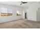Bright bedroom featuring carpeted floors and multiple windows with natural light at 15825 S 1St Ave, Phoenix, AZ 85045