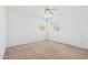 Bright bedroom with neutral carpet, ceiling fan, and ample natural light from two large windows at 15825 S 1St Ave, Phoenix, AZ 85045